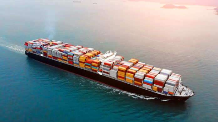Aerial view of cargo container ship on ocean.